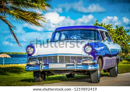 Havana, Cuba - June 30, 2017: American blue white Ford Fairlane classic car parked on the Malecon near the beach in Havana Cuba - Serie Cuba Reportage