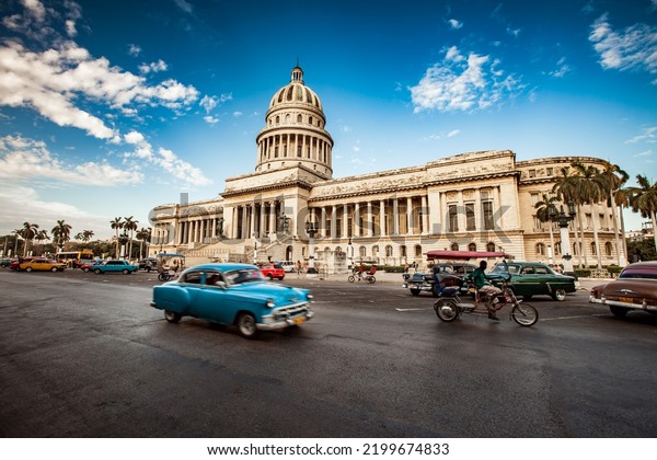 HAVANA, CUBA - JUNE 7, 2011: Old classic American\
car rides in front of the Capitol Havana. Before a new law issued\
on October 2011, cubans could only trade cars that were on the road\
before 1959.