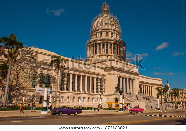 HAVANA, CUBA- MARCH 2018: Capitolio Nacional, El\
Capitolio. Old classic retro cars and motorbikes are on the way.\
Havana, capital of\
Cuba.