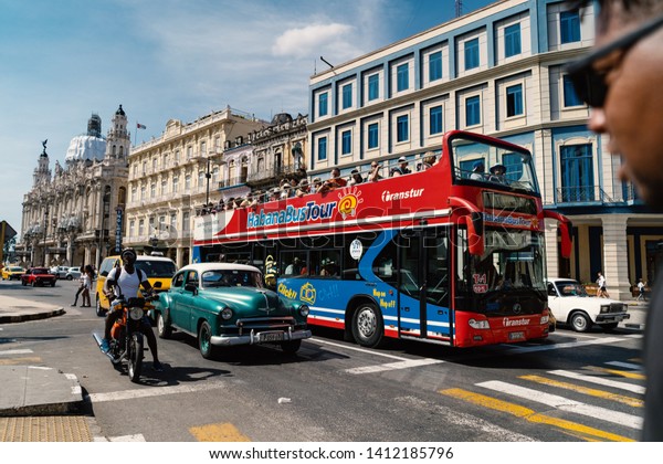 HAVANA, CUBA - MARCH 2019: Tourists on Habana Bus\
tour in the city.