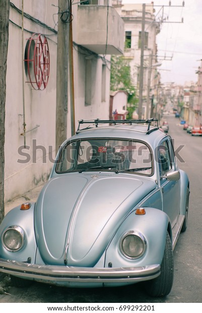 Havana, Cuba -\
MAY 15, 2017 : Classic german car (VW Käfer) parked on the street\
in Havana, These old and classic cars are an iconic sight of the\
Cuba Island, Havana, Republic of\
CUBA