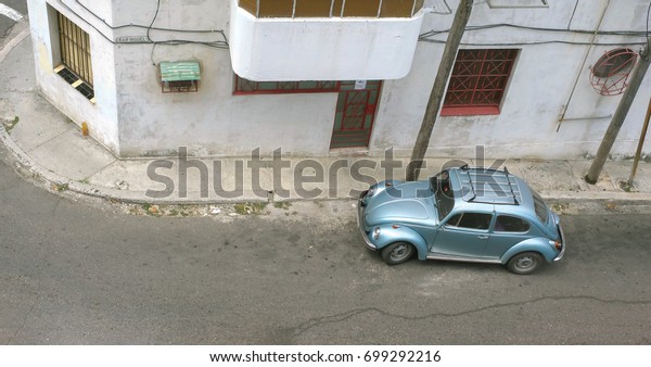 Havana, Cuba -\
MAY 15, 2017 : Classic german car (VW Käfer) parked on the street\
in Havana, These old and classic cars are an iconic sight of the\
Cuba Island, Havana, Republic of\
CUBA