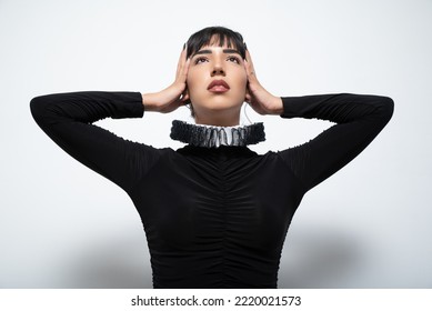 Havana, Cuba. May 23, 2022. Young Woman Wearing Ruff With Hands On Head Looking Up Against White Background