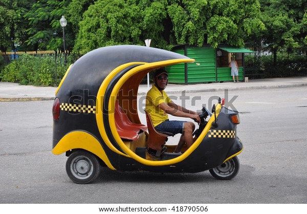 Havana, Cuba - November 27,\
2013: Coco taxi is a uniquely designed mode of transportation in\
Havana.