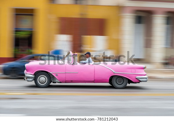HAVANA, CUBA - OCTOBER 21, 2017: Old Car in\
Havana, Cuba. Pannnig. Retro Vehicle Usually Using As A Taxi For\
Local People and Tourist. Orange\
Color