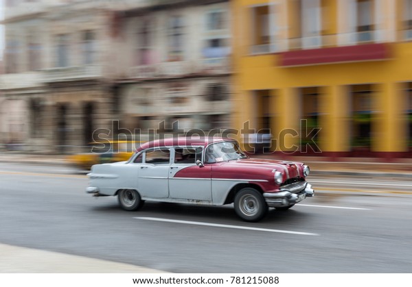 HAVANA, CUBA - OCTOBER 21, 2017: Old Car in Havana,\
Cuba. Pannnig. Retro Vehicle Usually Using As A Taxi For Local\
People and Tourist. Red\
Color