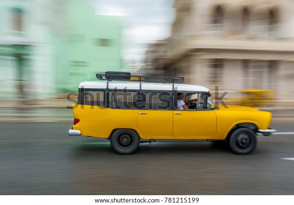 HAVANA, CUBA - OCTOBER 21, 2017: Old Car in\
Havana, Cuba. Pannnig. Retro Vehicle Usually Using As A Taxi For\
Local People and Tourist. Yellow\
Color