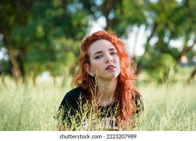 Havana, Cuba. September 18, 2021. Young Woman In Tall Grass Field Looking At Camera During Sunset 