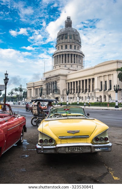 Havana, Cuba - September 22, 2015: \
Classic american car and Capitolio landmark in Havana,Cuba. Havana\
is tourist most popular destination in whole Cuba\
island.