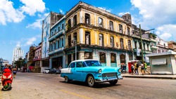 Havana, Cuba. Vintage Classic American Car On The Streets Of The Famous Vibrant Vibrant Capital Also Known As Habana. A Spontaneous Moment  Of Cheerful Tourists Enjoying Their Beautiful Vacation.