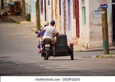 Havana, Cuba-March 2019: View Of A Motorcycle With Sidecar And Two People In One Of The Empty Streets Of The City