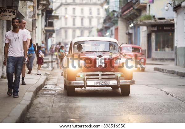 HAVANA, CUBA-OCTOBER 22:Colourful cars on\
streets of Havana in October 22, 2015 in Havana. With 2.4 mil.\
inhabitants in the city and 3.7 in its urban area,Havana is the\
largest city in the\
Caribbean