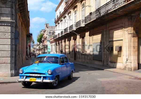 HAVANA - FEBRUARY 27: People ride Classic car on\
February 27, 2011 in Havana. Recent change in law allows Cubans to\
trade cars again. Old law resulted in very old fleet of private\
owned cars in Cuba.