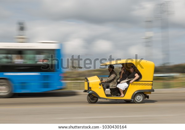 Havana, La Habana/ Cuba - Jan 27 2018:\
Transport in Havana (panning effect) - Tuk\
tuk
