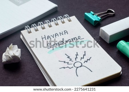 Havana syndrome text with hand drawn sketch on notepad. A mysterious illness, selective focus.