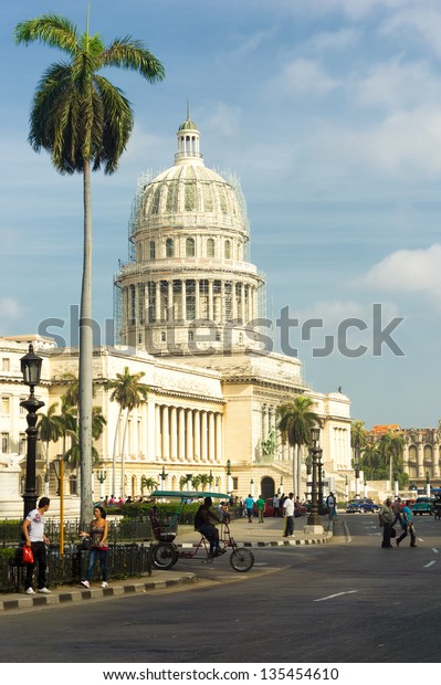 HAVANA-APRIL 4:People and traffic near the\
Capitol April 4,2013 in Havana.With 2.4 million inhabitants,Havana\
is the capital and the largest city in Cuba as well as its main\
touristic\
destination