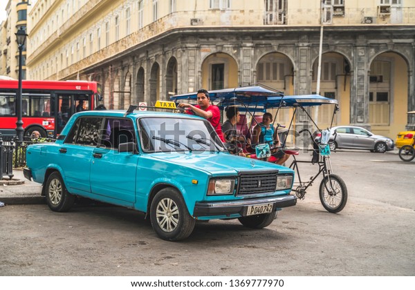 HAVANA,CUBA - MARCH 18,2019: Old Russian taxi car\
and driver, La Habana, Havana, Cuba, West Indies, Caribbean,\
Central America