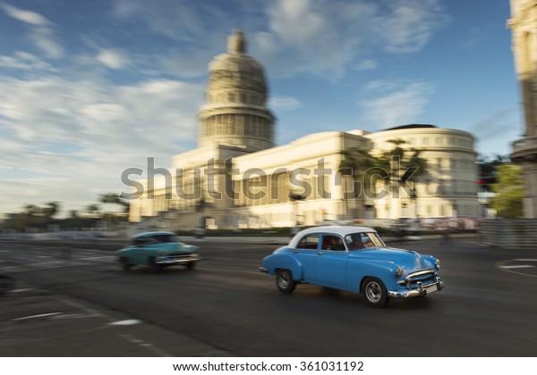 HAVANA,CUBA-OCTOBER 14:People and old car on\
streets of Havana October 14,2015 in Havana. With 2.4 mil.\
inhabitants in the city and 3.7 in its urban area, Havana is the\
largest city in the\
Caribbean