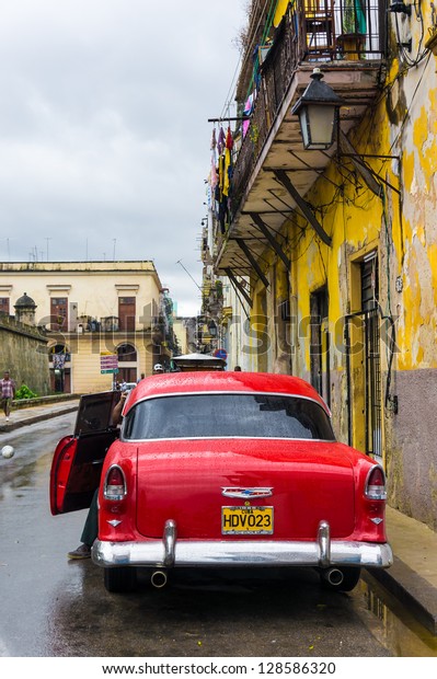 HAVANA-FEBRUARY 15:Antique red Chevrolet in the\
colonial town February 15,2013 in Havana.Thousands of these old\
american cars are still used in Cuba where they\'ve become a symbol\
of the country