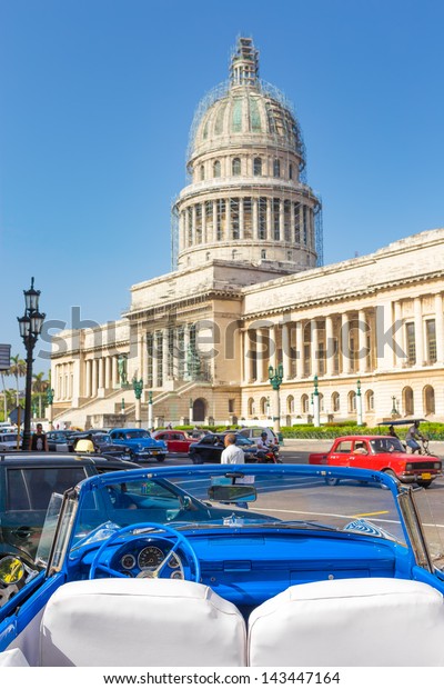 HAVANA-JUNE 21:Old american convertible car near the\
Capitol on June 21, 2013 in Havana. Before a new law issued on\
October 2011, cubans could only trade cars that were on the road\
before 1959