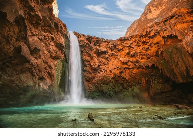 Havasu Falls is a waterfall of Havasu Creek in the Grand Canyon, Arizona, United States. It is within Havasupai tribal lands. Waterfall in nature - Powered by Shutterstock