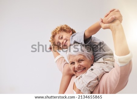 I have the best granny in the whole wide world. Shot of a grandmother giving her grandson a piggyback ride.