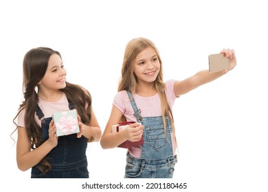 Have fun shooting selfies. Little models shooting selfies with mobile phone. Small girls taking photo shooting for sharing their images on social media. Adorable children enjoy their shooting session