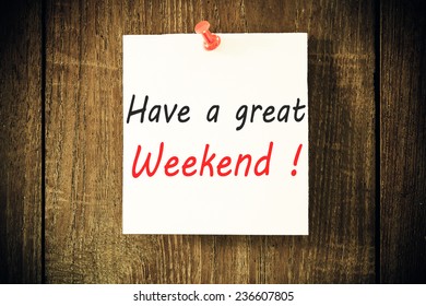 Have a great Weekend - Hand writing text on a piece of paper on wood background
