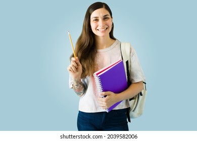 I Have An Idea. Smart Hispanic College Student Holding A Pencil And About To Write An Essay Or Homework