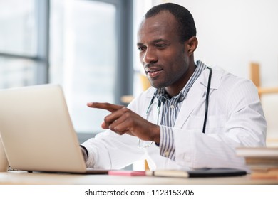 Have A Look. Concentrated Medical Worker Reading Scientific Article While Having Break