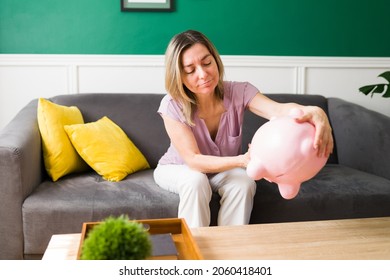 I Have No Money Left. Sad Senior Woman Emptying Her Piggy Bank To Pay For Her Debts