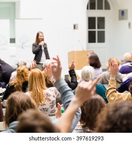 I Have A Question. Group Of People Sitting At The Chairs In Conference Hall, Raising Their Hands. Workshop At University. Business And Entrepreneurship Event.