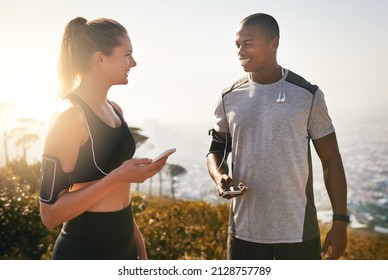 Have You Got Your Running Playlist Ready. Shot Of A Fit Young Couple Working Out Together Outdoors.