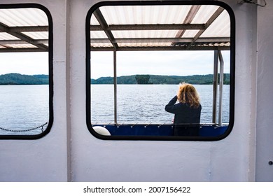 Haverud, Sweden July 2, 2021 A Woman Passenger On A Canal Boat Along The Dalsland Canal In Western Central Sweden.