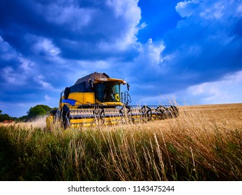 Havest Time Agriculture Industry, Farm Equipment And Harvester In Action