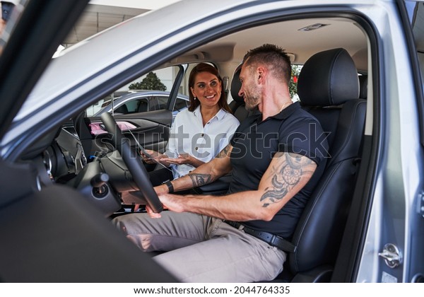 Having friendly conversation in the car salon\
in dealership