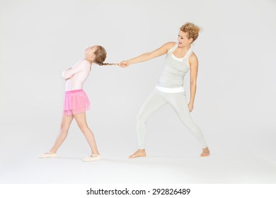 Having Fun / Mother Pulling Her Daughters Fishtail Braid