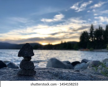 Having fun with the rocks while watching a sunset at a lake.