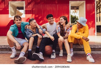 Having A Good Time With Friends. Group Of Multiethnic Young People Enjoying Hanging Out Together Outdoors In The City. Cheerful Generation Z Friends Having Fun And Making Happy Memories.