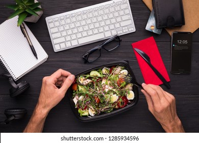 Having Lunch At Workplace. Businessman Enjoying Healthy Salad At Work Desk, Top View