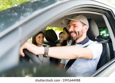 Having So Much Fun During The Road Trip. Young Parents Driving Their Kids To The Beach. Mom And Dad Laughing And Joking With Their Kids While Traveling By Car 