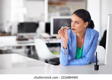 Having a quick vape between meetings. Shot of a businesswoman smoking and electronic cigarette in an office. - Powered by Shutterstock