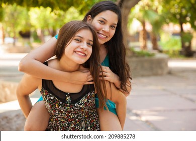 Having Some Fun Piggyback Riding My Best Friend While Hanging Out At A Park