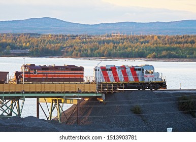 Havre St. Pierre, Quebec/Canada - September 23 2019: Locomotives Belonging To The Rio Tinto Company Are Busy At Work Hauling Wagons Full Of Ore.