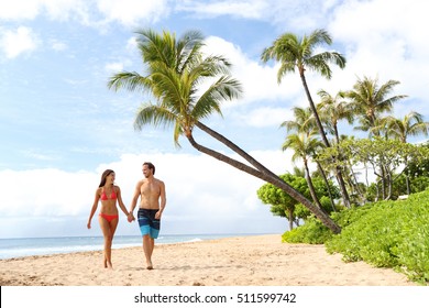 Hawaii Beach Couple Walking On Hawaiian Beach, Kaanapali Beach, Maui, Hawaii, USA. Travel Vacation Asian, Caucasian Couple Relaxing On Famous Hawaiian Beach Destination For Summer Travel Holidays.