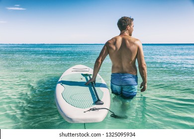 Hawaii Beach Fitness Watersport Man With SUP Paddle Board Doing Stand Up Paddle Boarding In Water.