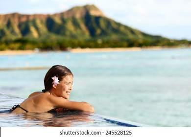 Hawaii Beach Travel Vacation Woman Swimming Relaxing At Luxury Pool Hotel Resort. Asian Young Adult On Waikiki Beach, Honolulu, Oahu On Exotic Holidays