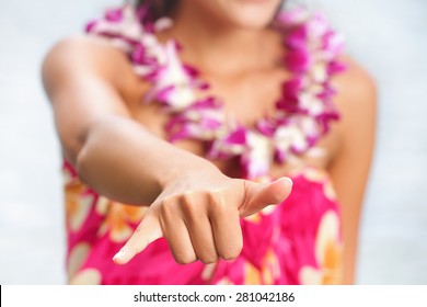 Hawaii Beach Woman Making Hawaiian Shaka Hand Sign Wearing Lei Of Flowers. Hawaii, USA.