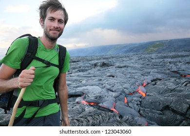 Hawaii Hiker Hiking By Flowing Lava From Kilauea Volcano Around Hawaii Volcanoes National Park, USA. Young Caucasian Man..