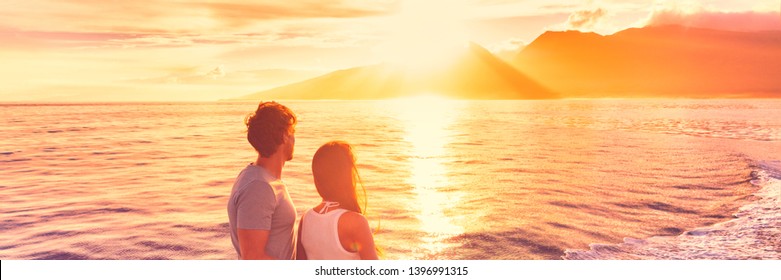 Hawaii holiday cruise ship tourists couple watching sunset on honeymoon travel vacation. Banner panoramic view of Kauai island.